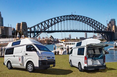 Two campervans in front of Sydney Harbour Bridge