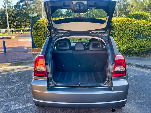 Used Dodge for sale - Automatic 2011 model - photo showing the tailgate open and loads of bootspace