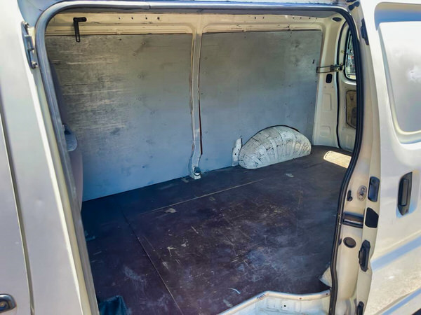 Toyota Hiace for sale - Plain white panel van ready for campervan conversion - photo showing the side sliding door and the view of the back of the van with floor boarded out