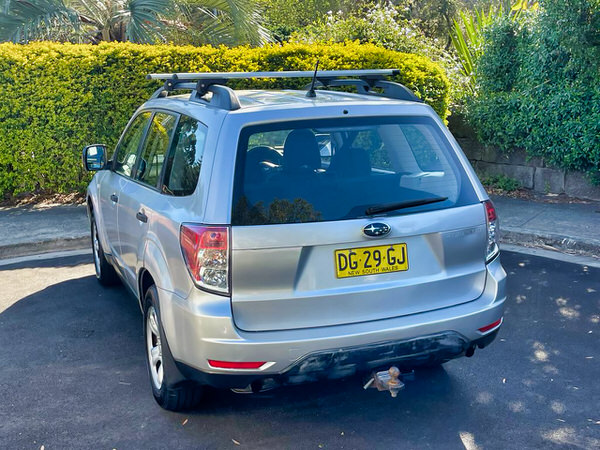 Subaru Forester for sale - metallic silver 2009 model - photo showing the view from rear passenger side angle view with roof bars