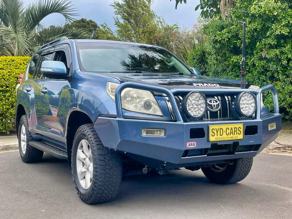Used Toyota Prado for Sale - Automatic Model with heavy duty Roo bars and Spot lights - photo showing the front drivers side angle view of this used Prado