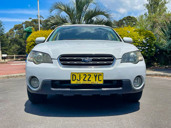 Used Subaru for sale - Model shown is a White Automatic Subaru Outback - photo of the view from the front of the vehicle with colour coded bumpers and front grille