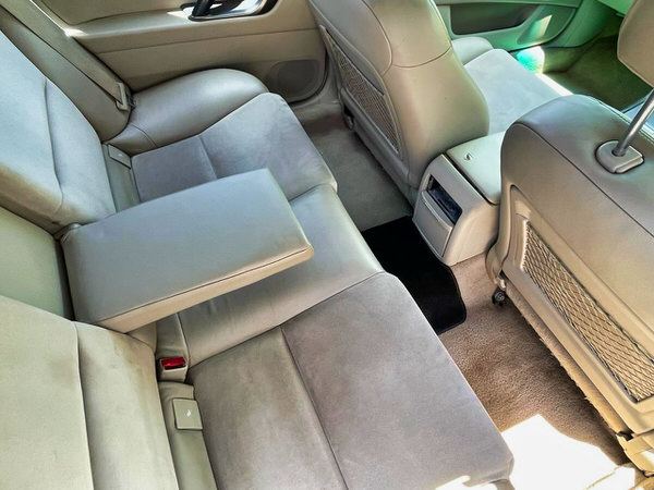 Used Subaru for sale - Model shown is a White Automatic Subaru Outback - photo of the view from the rear seats with a pull down wide central arm rest for the back seat passengers - great for kids