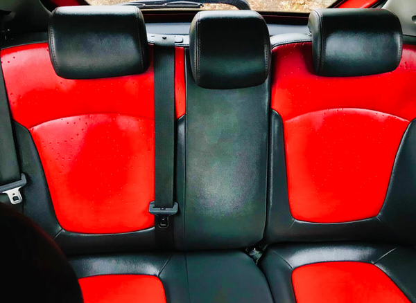 Used Holden Barina for sale in Sydney - Model shown is the 2011 Holden Barina Spark CDX in Red - photo shows the striking red and black leaather sports seat designed rear seats
