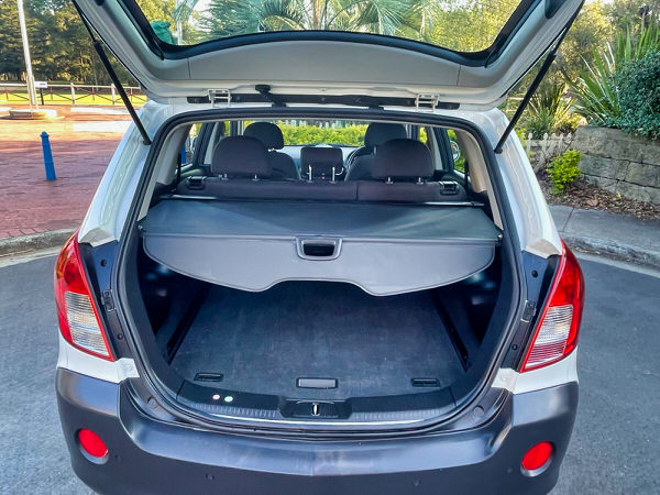 Used Holden Captiva for sale in Sidney - automatic five seater model - photo showing the rear tailgate opened and the parcel shelf and all the space in the boot 