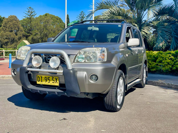 Small SUV for sale - Nissan X-Trail 2004 Model with twin headlamps - Photo showing the front passenger side angle view