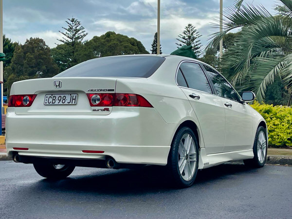 Used Honda Accord for sale in Sydney - Automatic white 2003 Model. Photo showing the rear driver side angle view