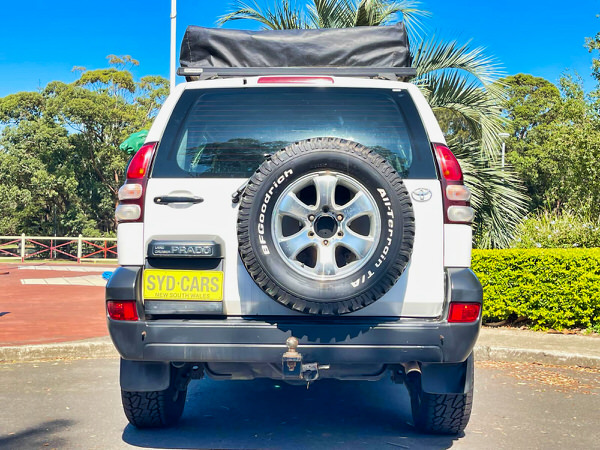 Used Toyota Prado for Sale - Manual 2008 Turbo Diesel Model with heavy duty Roo bars and roof rack + Roof Top Tent - photo showing the rear angle view with roobars and the roof top tent folded away 
