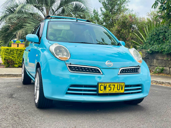Nissan Micra for sale in Sydney - 2010 Automatic Model in stunning Baby Blue Colour - photo showing the front driver side angle view shot from a low angle 