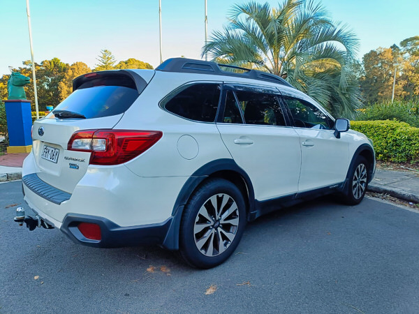 Used Subaru for sale - Fantastic Online Customer Reviews - Model shown is the 2016 white 2.0L Turbo Diesel Subaru Outback - Photo showing the rear driver side angle view