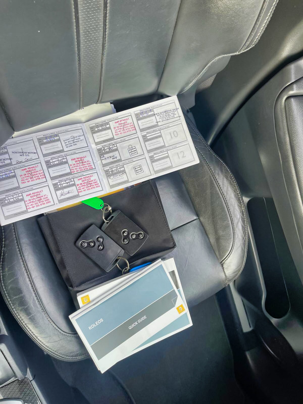 Used SUV for sale in Sydney - used Renault Kleos 2010 Automatic model with full service history books - photo showing the front seat with the official service history book open with service stamps for the history of the lifetime of the car