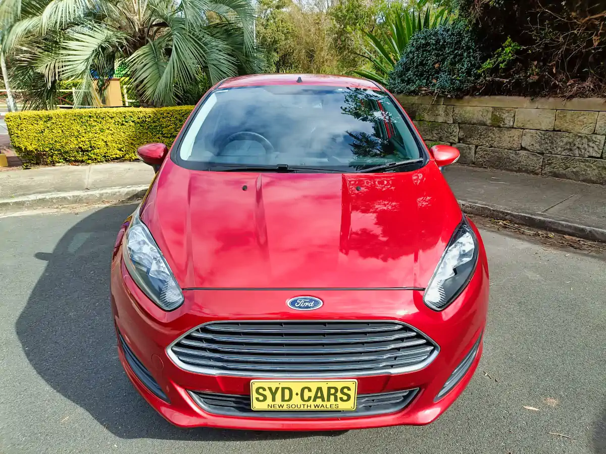 Front straight on view showing colour matching front bumper and grille on this red used Ford Fiesta for sale
