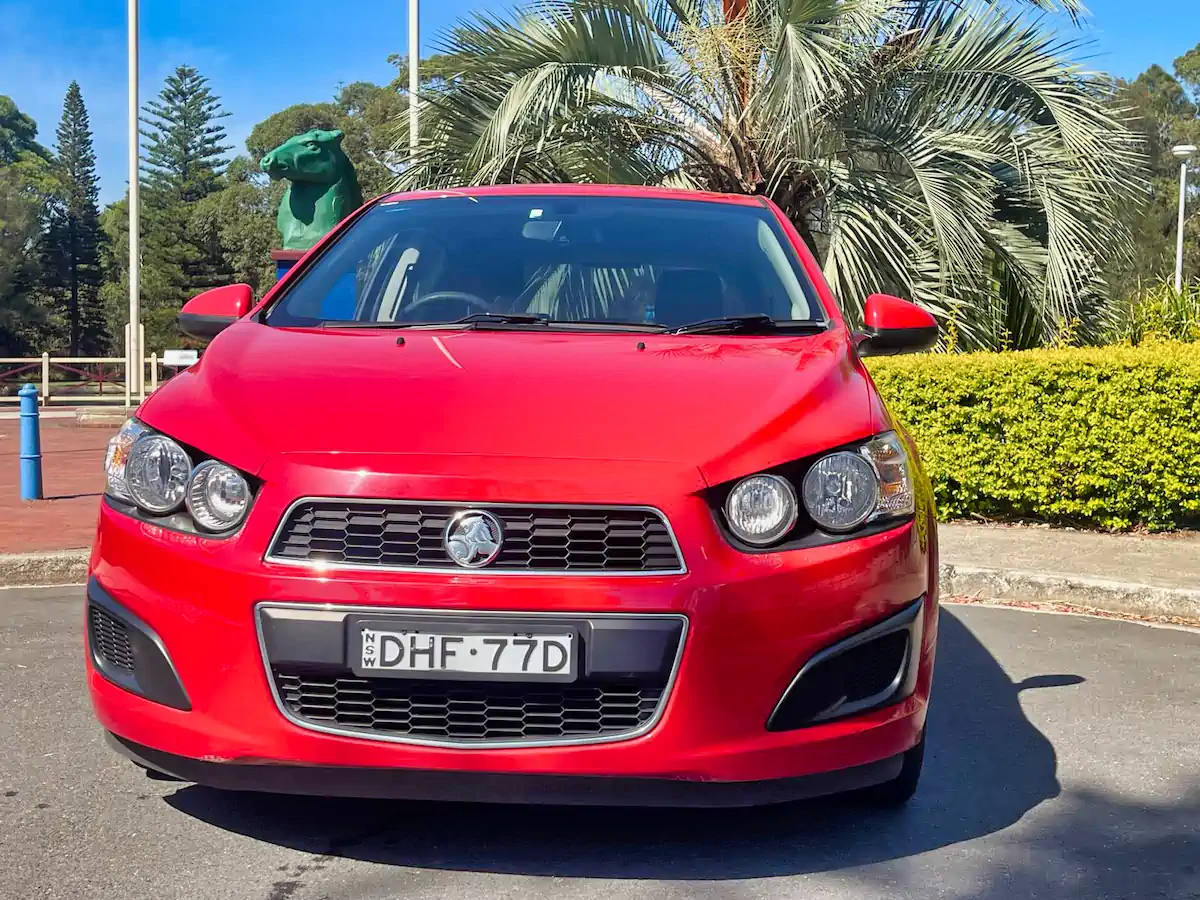 front bumper and grille view of the red automatic Holden Barina hatch
