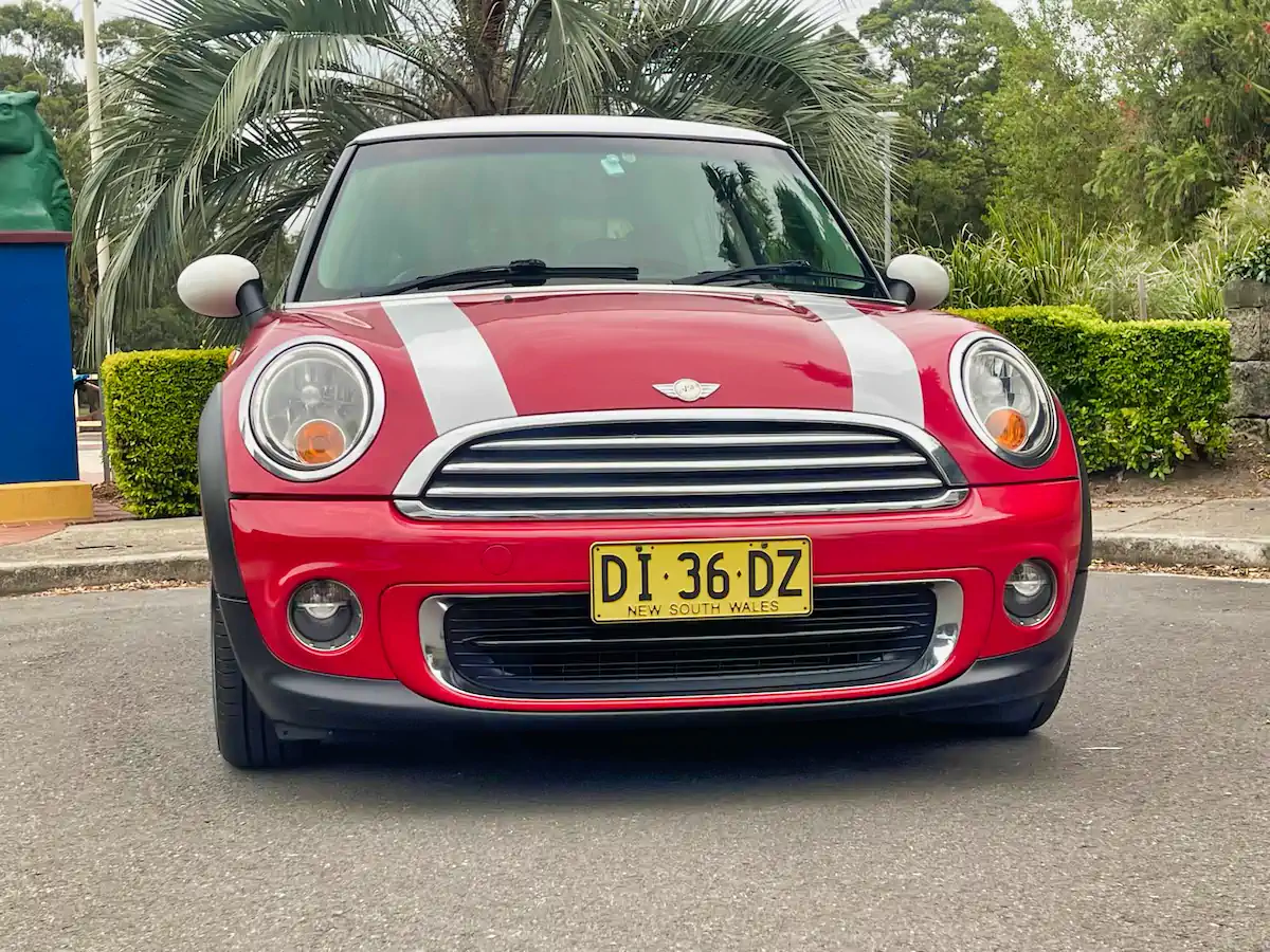Front view of the red 2012 Mini automatic - stylish grille and iconic headlights